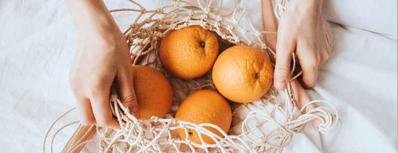 cream net bag full of oranges - a great source of vitamin c