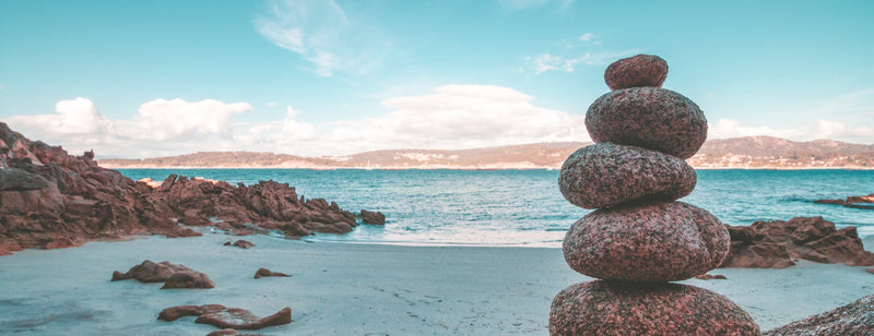 Zen beach with rocks stacked up