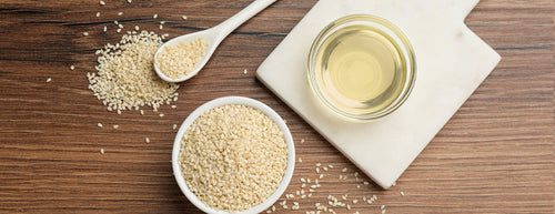 Lecithin granules and Lecithin oil, in a bowl and wooden spoon, on a wooden table