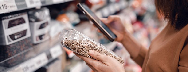 woman trying to understand food label at the supermarket