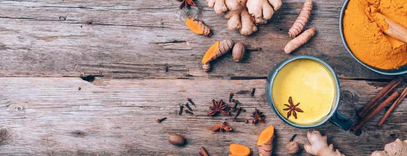 turmeric latte in cup with spices and cinnamon