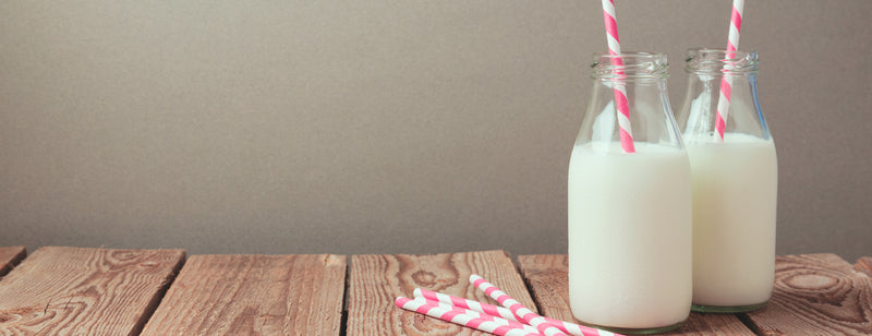 mini glass bottles of milk with retro striped straws