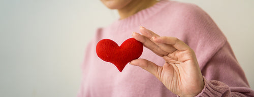 woman holding red heart in honour of heart health