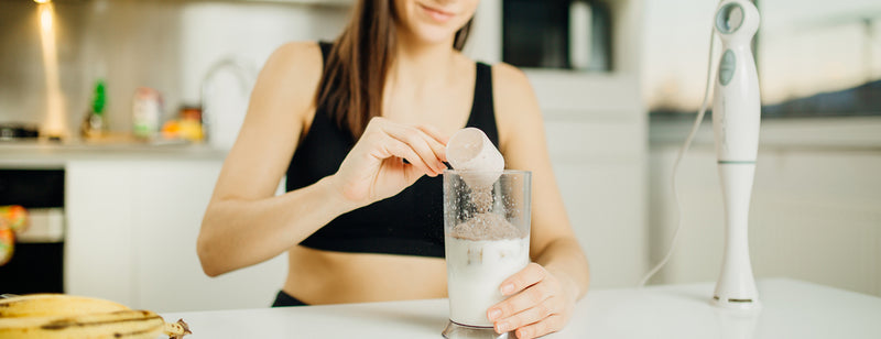 woman making a smoothie using amino acids