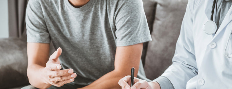 man having consultation with doctor over men's health issues