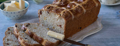 White Spelt Hot Cross Bun Loaf with butter and tulips 