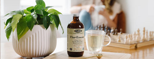 flor essence supplement with green plant and woman relaxing in background