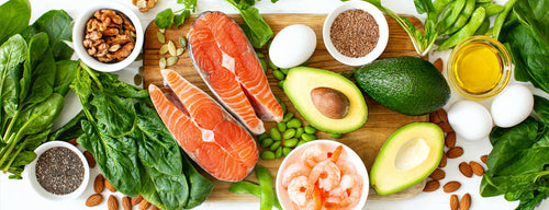 slection of healthy foods including greens, salmon and vegetables