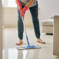 mopping a floor with rubber gloves on