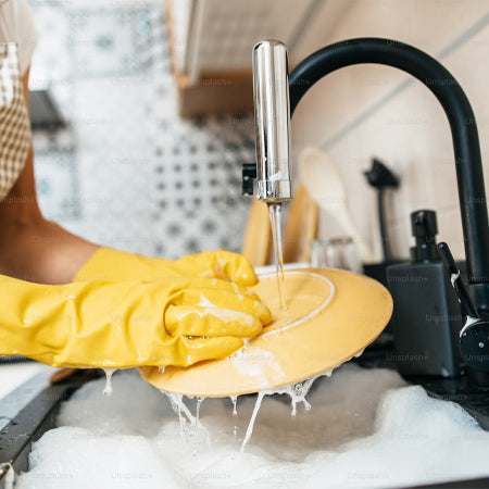 washing dishes at a kitchen sink