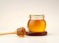 jar of manuka honey on stand with honey dipper