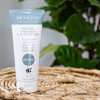 MooGoo Body Care skin milk udder cream product on basket with greens