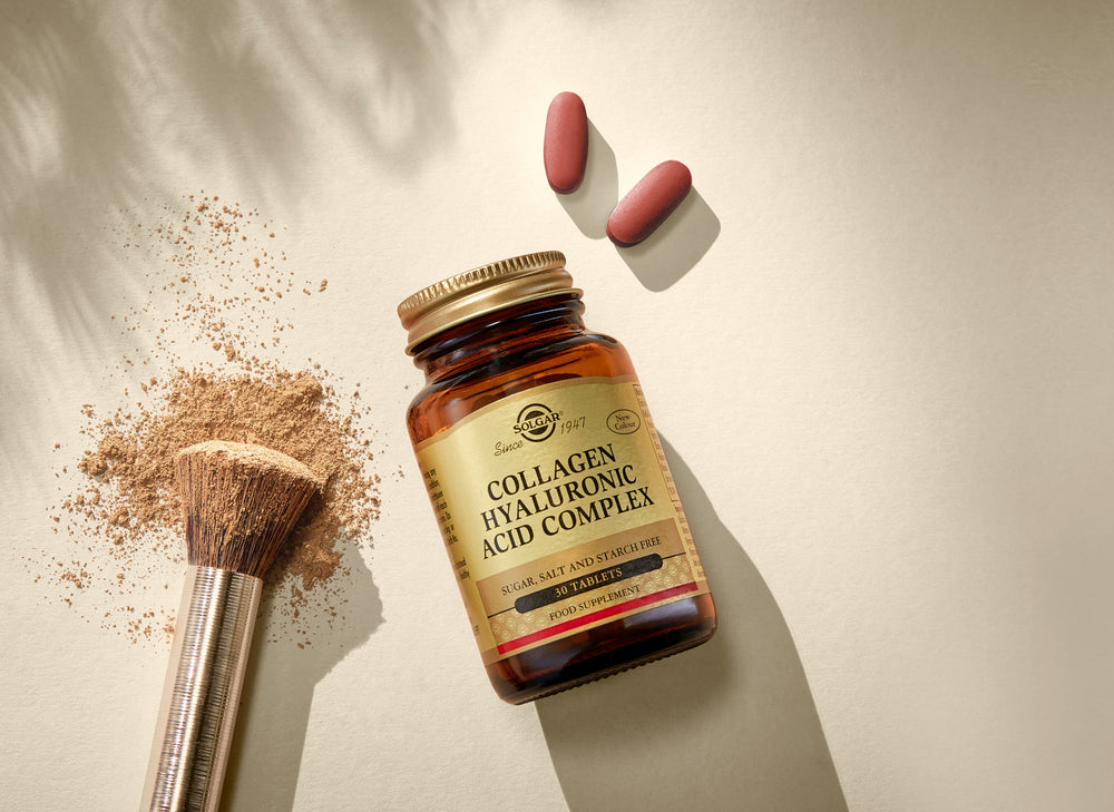 bottle of solar collagen complex on a beige background with make up brush and tablets