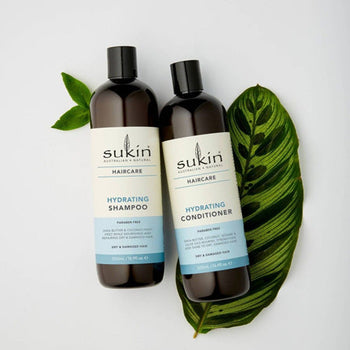 Sukin Hair Care with green leaves 