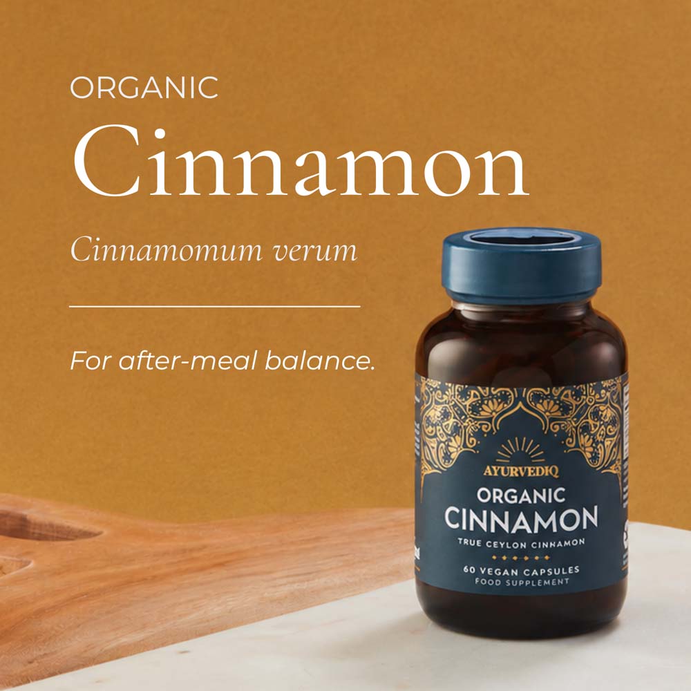 A bottle of Ayurveda Organic Cinnamon capsules on a light surface, with large text reading &