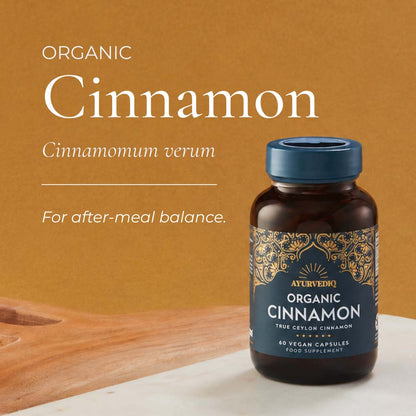 A bottle of Ayurveda Organic Cinnamon capsules on a light surface, with large text reading &