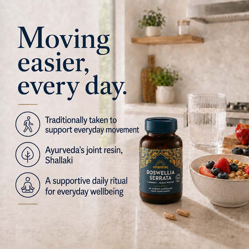 A bottle of Boswellia Serrata dietary supplement placed on a kitchen countertop beside a glass of water, with the informational text &