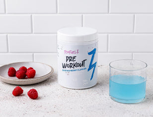 Fem Fuelz Pre-Workout tub with dish of raspberries