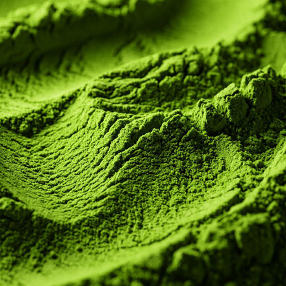 Close-up of bright green powder with textured ridges and soft shadows, filling the frame.