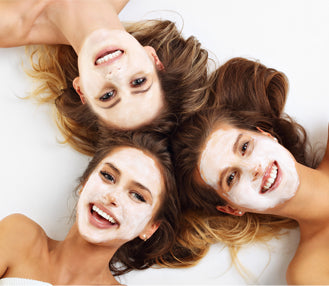 3 girls lying down with face masks on face