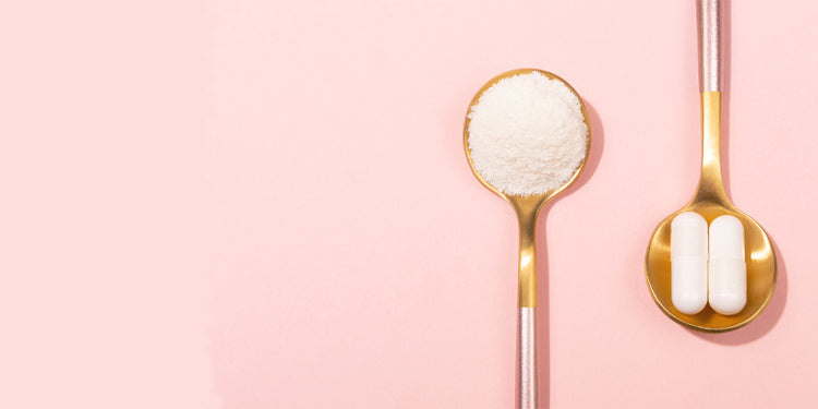 Gold spoons holding white collagen powder and white capsules on pink background
