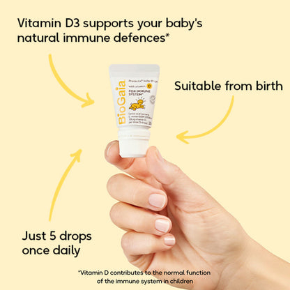 Hand holding a BioGaia vitamin D3 supplement with text about its benefits on a yellow background
