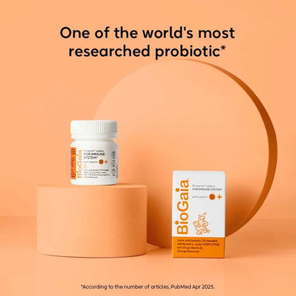 BioGaia Probiotic supplement shown with a white bottle and white-and-orange box on peach-colored pedestals against a peach background, with the headline &