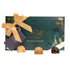Dark green and gold gift box of Irish Artisan Chocolates by The Chocolate Garden of Ireland, tied with a peach bow, shown with three sample chocolates: white chocolate with red drizzle, milk chocolate, and dark chocolate.