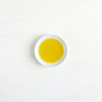 A small white round dish filled with Clearspring olive oil.