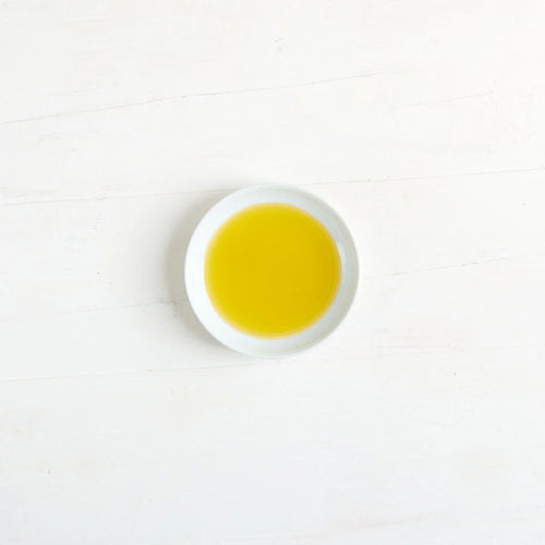 A small white round dish filled with Clearspring olive oil.