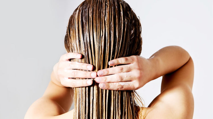 Woman applying conditioner to wet hair