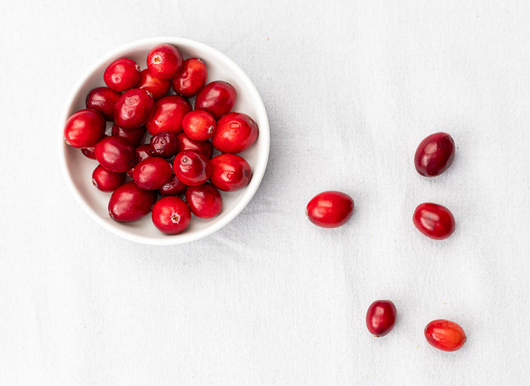 bowl of fresh cranberries on a white table cloth