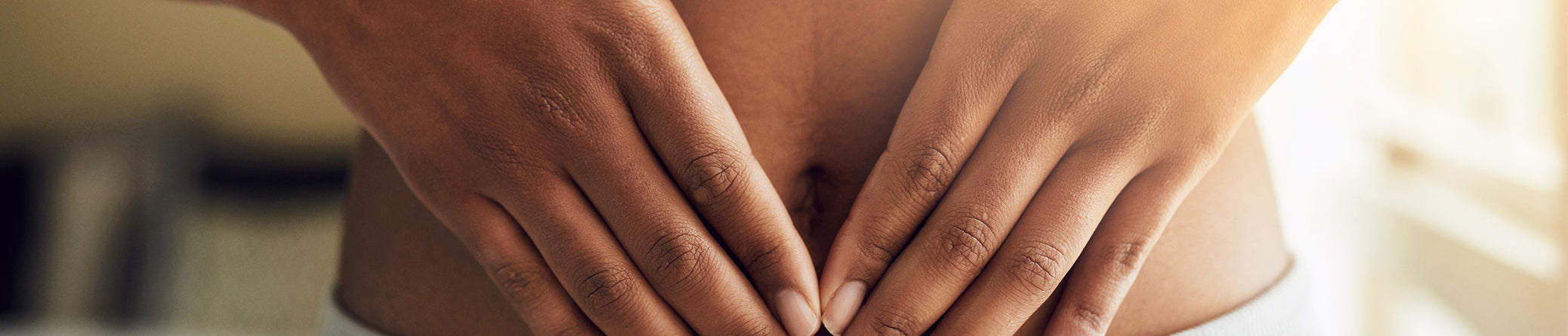 hands holding a bare tummy