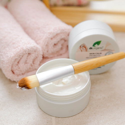 Cosmetic jar with a brush, towel, and container labeled &