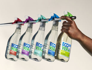 Ecover spray cleaning bottles hanging on silver rod