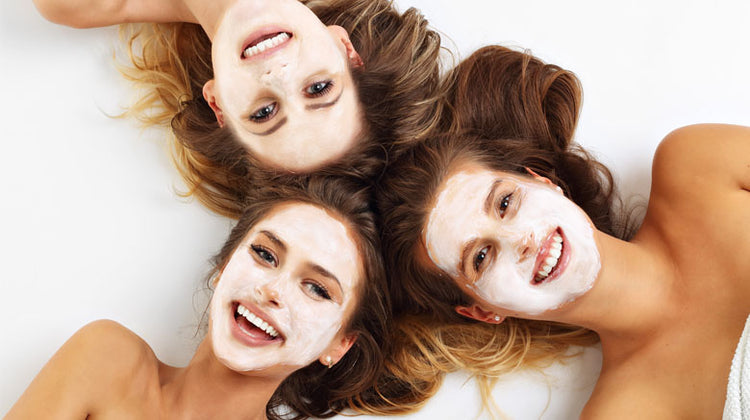 3 young women lying down with face masks on