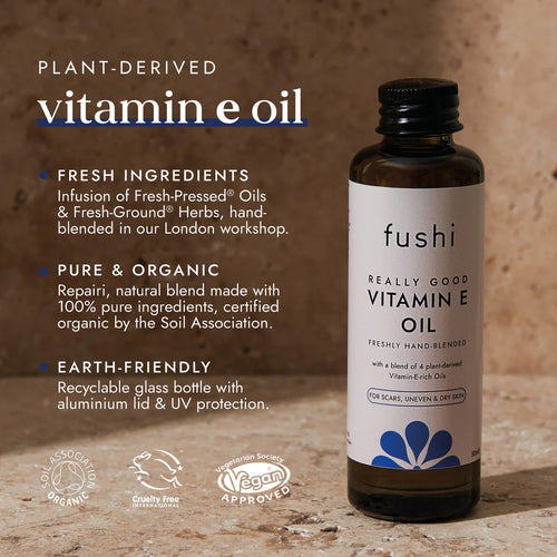 Fushi Vitamin E oil bottle with product details on a wooden background