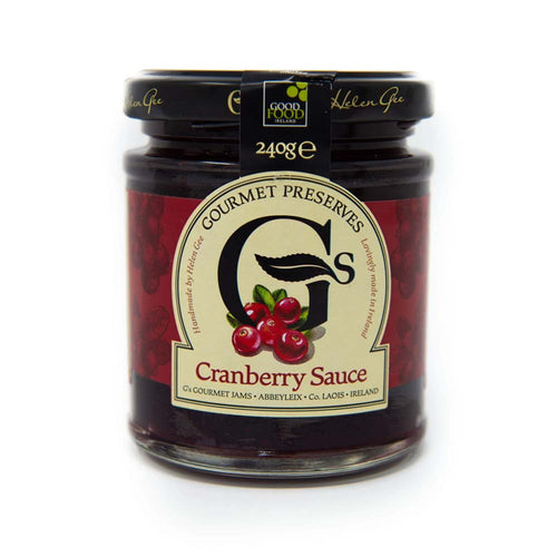 A glass jar of Good Food Centre Gourmet Preserves Cranberry Sauce, featuring a cream and red label with cranberry illustrations and a black lid.