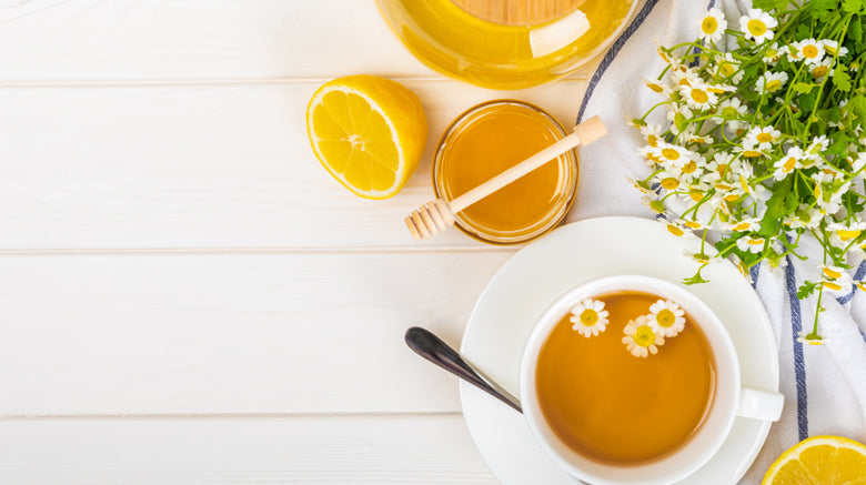Cup of chaomile tea with chamomile flowers
