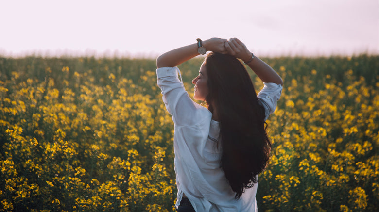 happy woman walking in a floral field