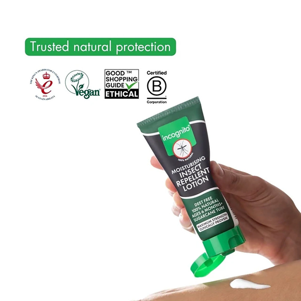 Hand holding a tube of Incognito insect repellent lotion with certification logos on a white background