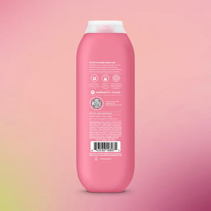 Pink shampoo bottle with label on a pink gradient background