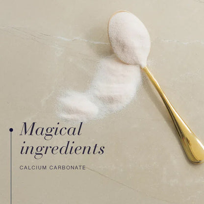 Gold spoon with calcium carbonate powder on a beige surface, text &