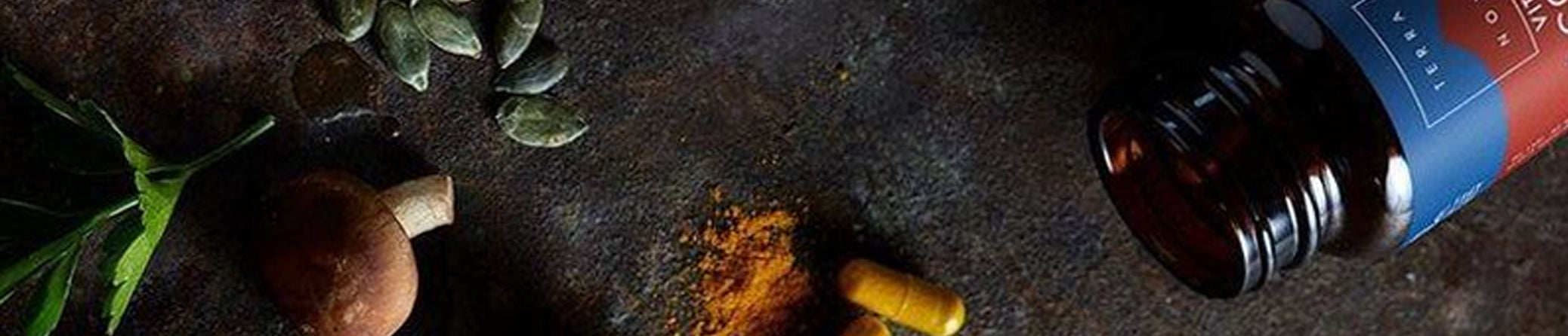 Bottle of terranova on a dark surface with spices and leaves