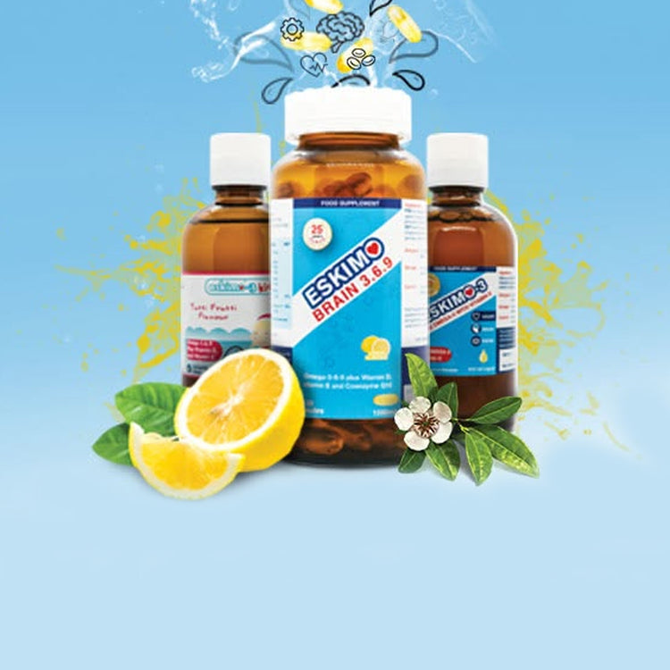 Three amber glass bottles of Eskimo-3 arranged on a light blue background with a lemon slice and green leaves.