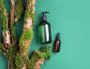 green cosmetic bottles on green background