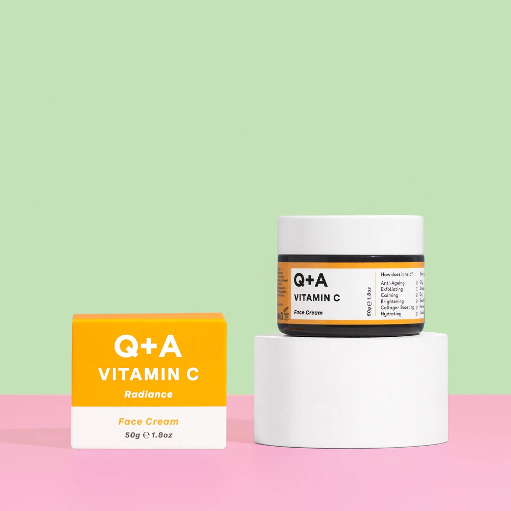 Q+A Vitamin C face cream jar and box on a pink and green background