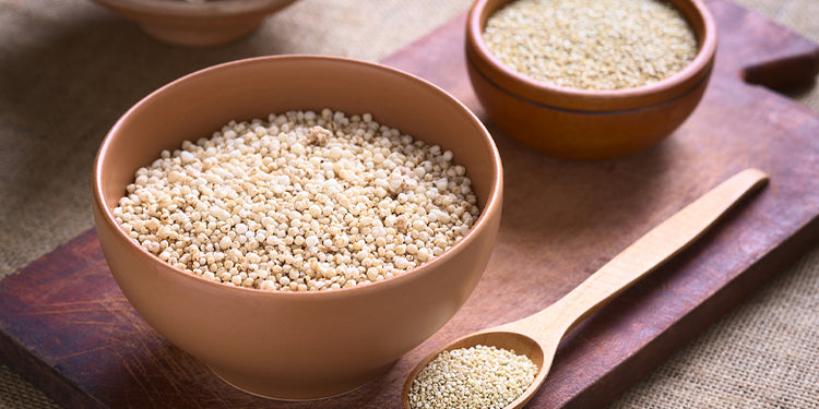 quinoa grain in wooden bowl and spoon