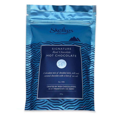 Metalic blue resealable pouch of Skelligs Chocolate Signature Real Hot Chocolate featuring a dark blue label with stylized ocean wave graphics.