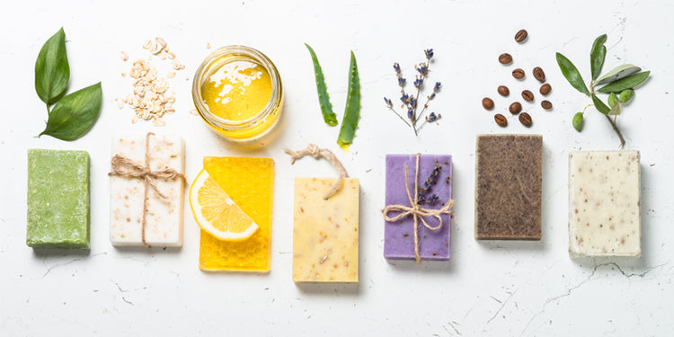 bars of handmade soap shown with raw ingredients